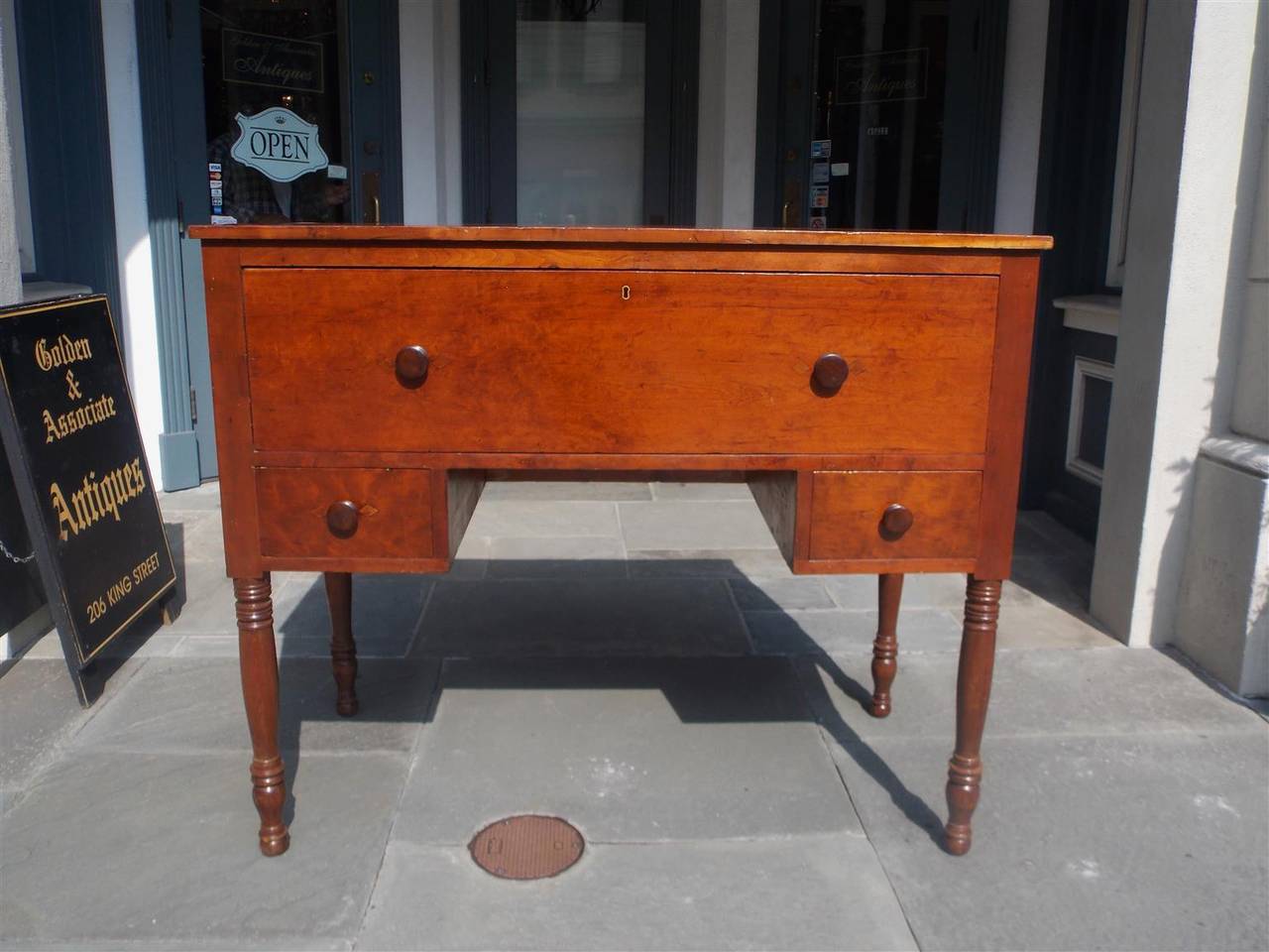 American Sheraton cherry hunt board with fall front desk, fitted interior with upper drawers and scalloped pigeon holes, mahogany knobs and terminating on turned ringed bulbous legs. Secondary wood consist of poplar, Early 19th Century.