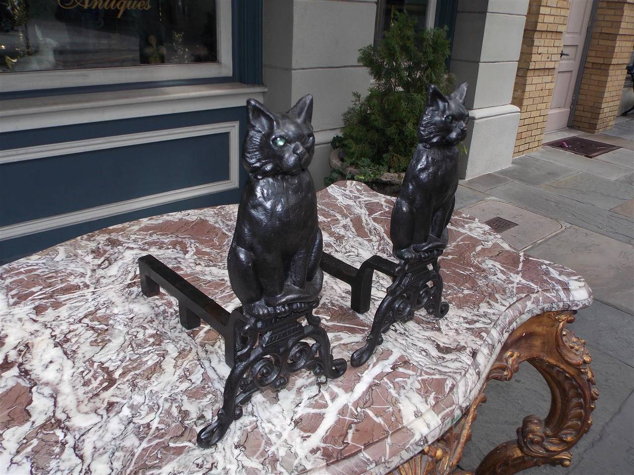 cat andirons with glass eyes