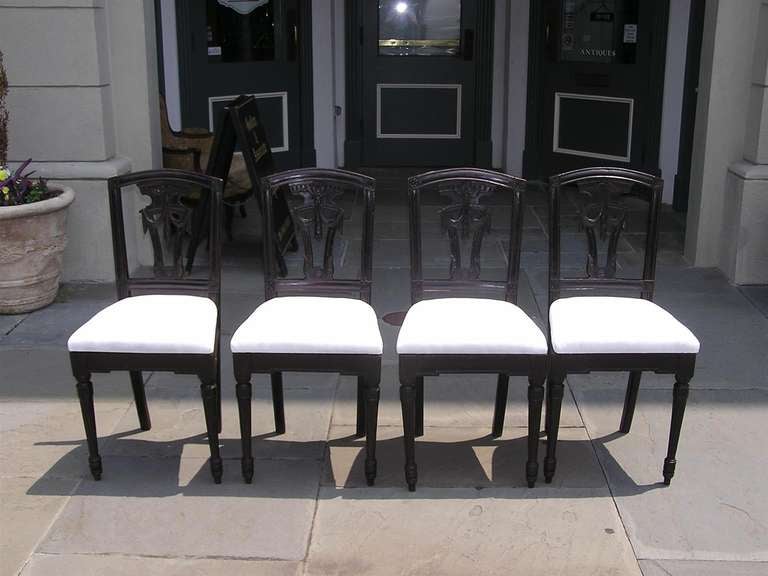 Set of four Italian mahogany side chairs with carved floral corner medallions, splat back with acanthus floral swags, and terminating on fluted bulbous legs.  Chairs are upholstered in white Muslin.  Dealers please call for best price.