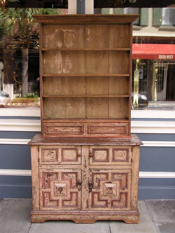 French painted four door step back cupboard with removable shelves, wooden knobs, and bracket feet.