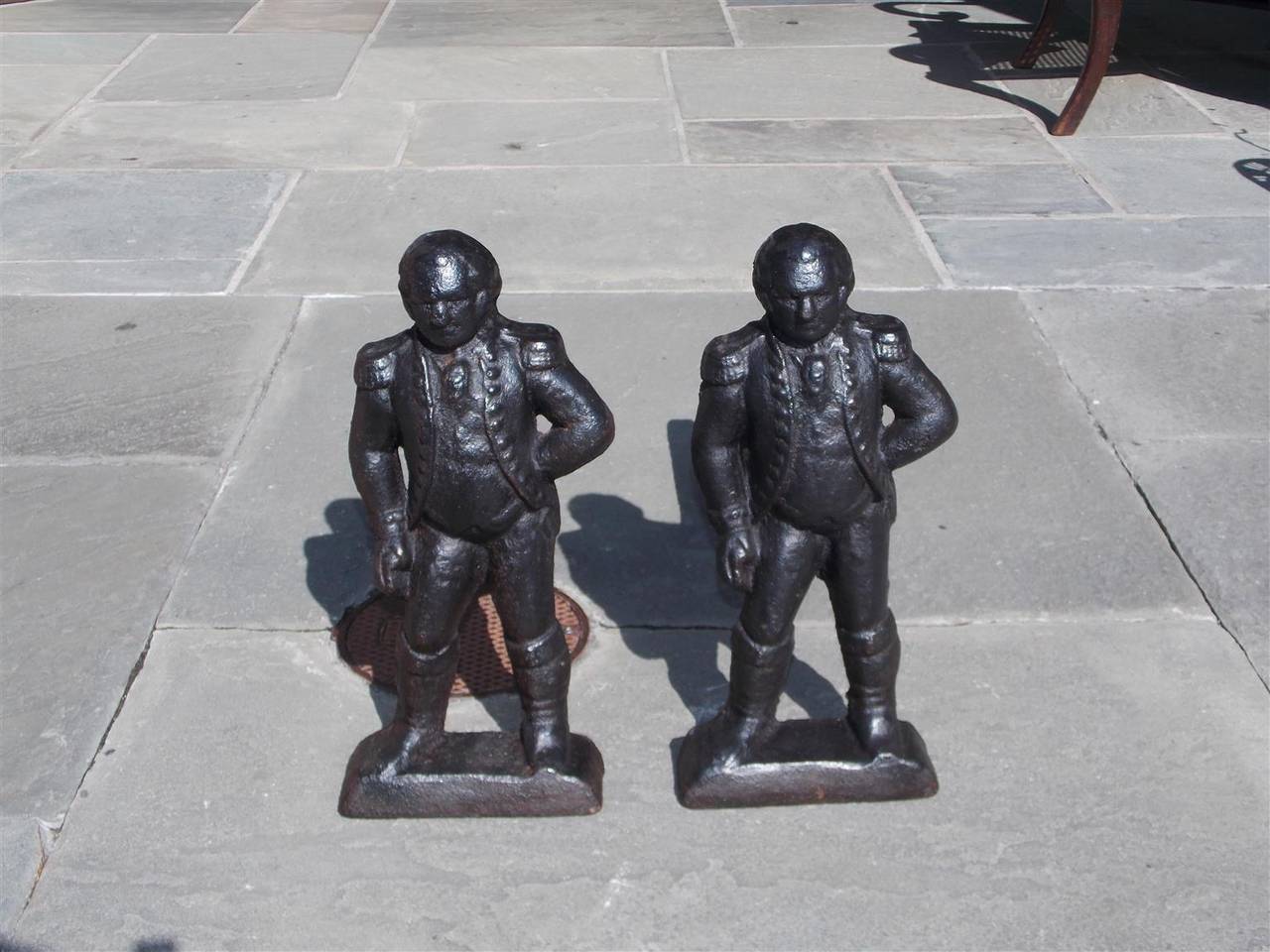 Pair of American cast iron George Washington Andirons standing in Military Dress Attire with the original dog legs. Early 19th Century.
