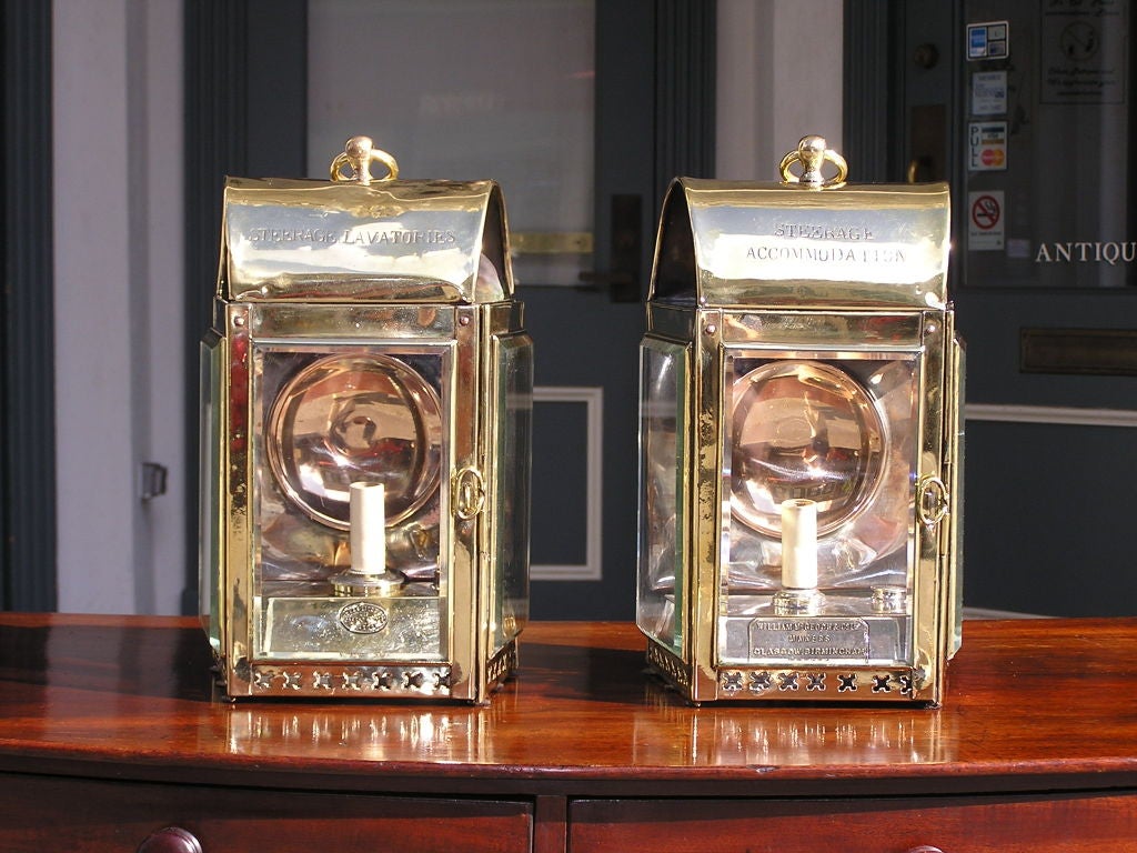 Pair of English brass, nickel silver, copper mounted ship lanterns with dome vented top, pierced gallery, and original beveled glass. Signed by maker. Originally oil and has been electrified.