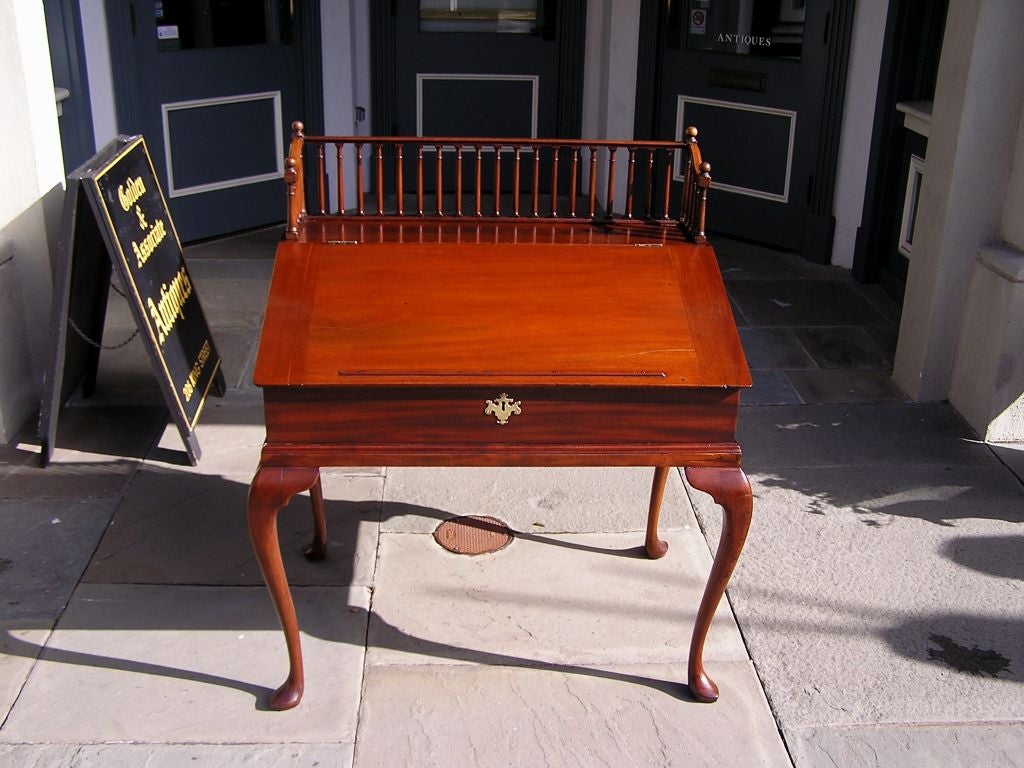 American Cuban mahogany slant top desk with turned ball finial gallery, fitted interior drawers, and ending on cabriole legs with slipper feet.