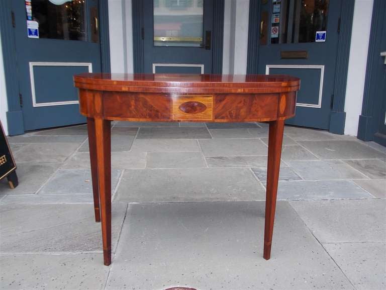 American mahogany one board flip top game table with Satinwood and Lace wood inlay, terminating on tapered squared  cuffed legs.  Dealers please call for trade price.