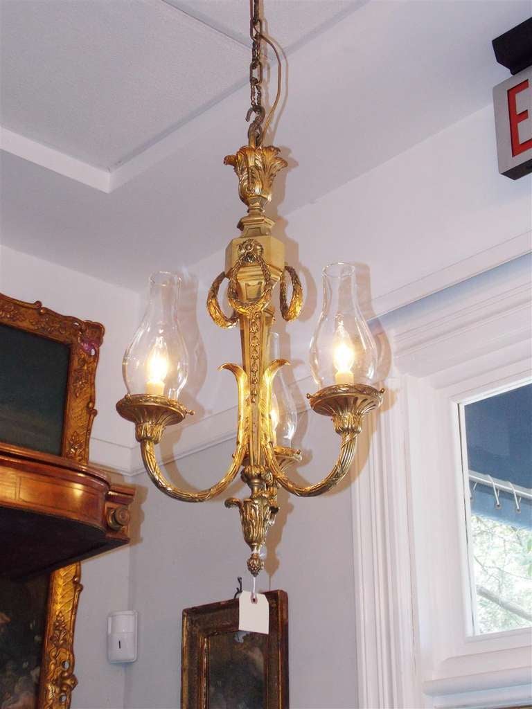 French gilt bronze three light globe chandelier with acanthus, laurel wreath, and bell flower foliage.  Originally candle powered and has been electrified.  Dealers please call for trade price.
