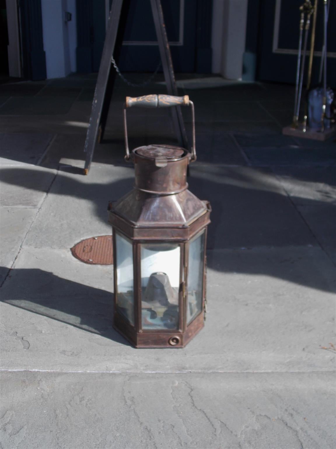 English polished steel nautical yacht cabin lantern with wooden carrying handle, vented chimney, three glass panels, porcelain back, and original oil burner, Mid-19th Century. Stamped Best and Lloyd, Birmingham.