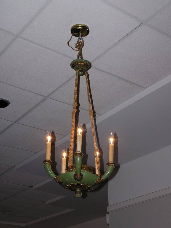 Italian five light hand carved, painted, and gilt chandelier supported by original canopy and braided rope motif. Originally candle powered.