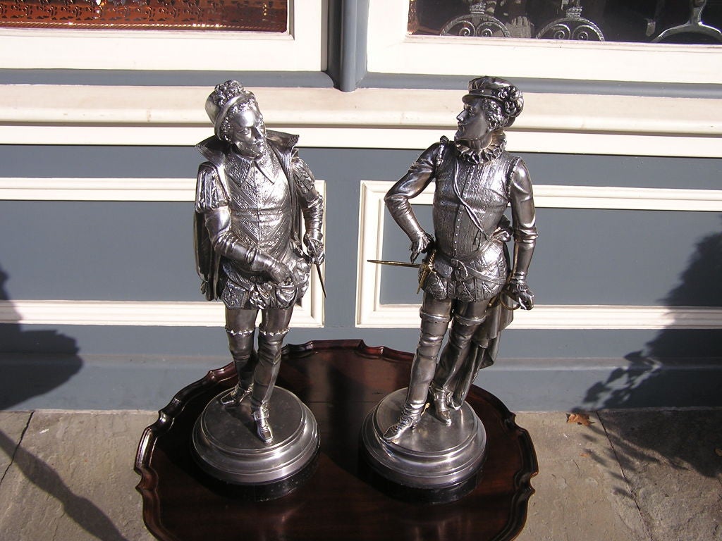 Late Victorian Pair of English Spelterware Cavaliers Mounted on Ebonized Circular Bases. C.1900
