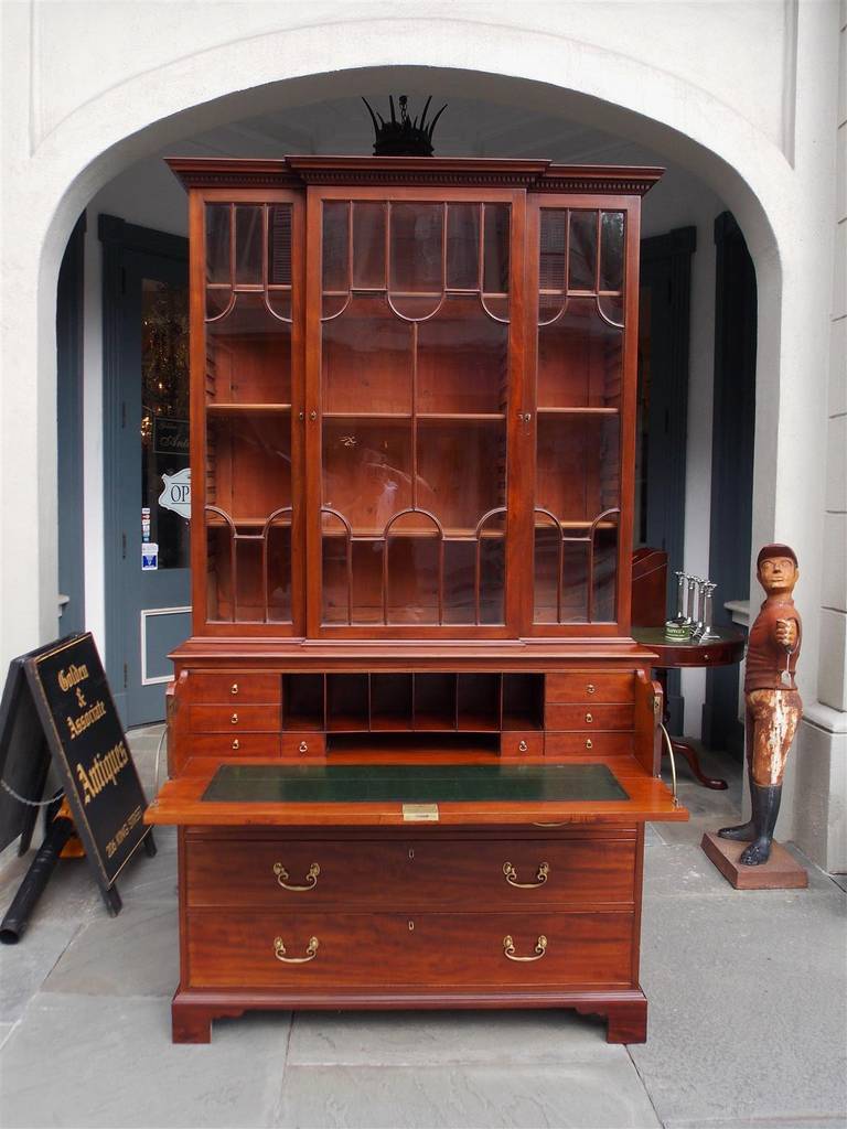 English Regency mahogany fall front secretary bookcase with dental molding, adjustable interior shelving, fitted interior desk, leather writing surface, original brasses, and terminating on original bracket feet.  Late 18th Century