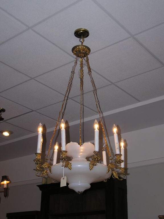 French opaline nine light chandelier suspended by original canopy and floral ormolu chain. The chandelier has the original floral ormolu scrolled candle holders as well. Originally candle powered.