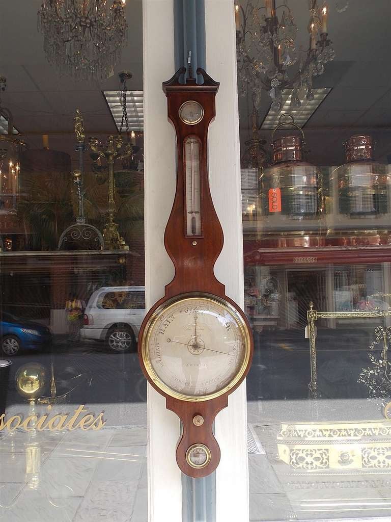 English mahogany banjo barometer with arched broken pediment, Satinwood and Rosewood inlay, thermometer, barometric pressure gauge, original  knob, and enclosed glass level.  Paper label on back reading  J. Somalvico and Co. London.   Dealers please