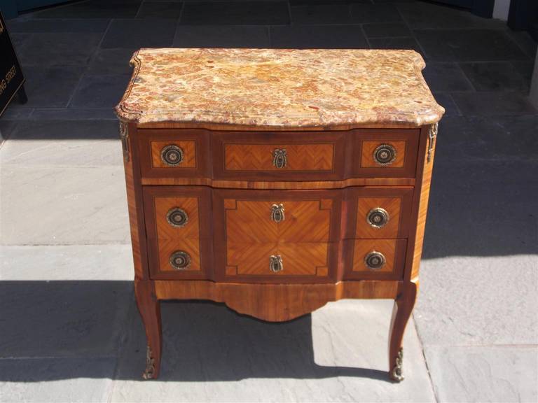 French marquetry three drawer marble top commode with original ormolu mounts and brasses, and terminating on stylized cabriole legs.  All original.  Early 19th Century.