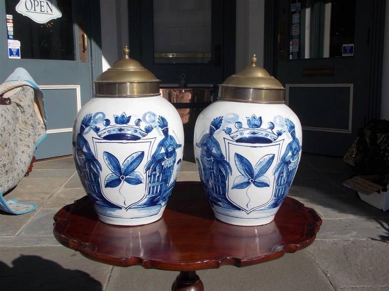 Pair of Dutch delft hand-painted and glazed tobacco jars with original brass lids. Late 18th century.