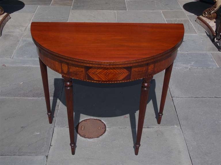 American mahogany flip top demi-lune game table with double gate legs, Burl walnut skirt, intricate inlaid Satinwood, terminating on bulbous reeded legs.  Dealers please call for trade price.