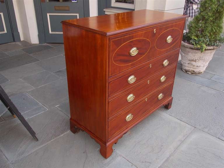 American mahogany fall front butler's desk with oval satinwood string inlay, fitted interior, original brasses, and terminating on bracket feet.  Baltimore.