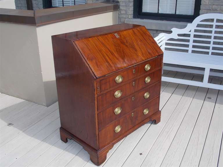English mahogany slant front desk with fitted interior, hand tooled leather,and terminating on original bracket feet. 