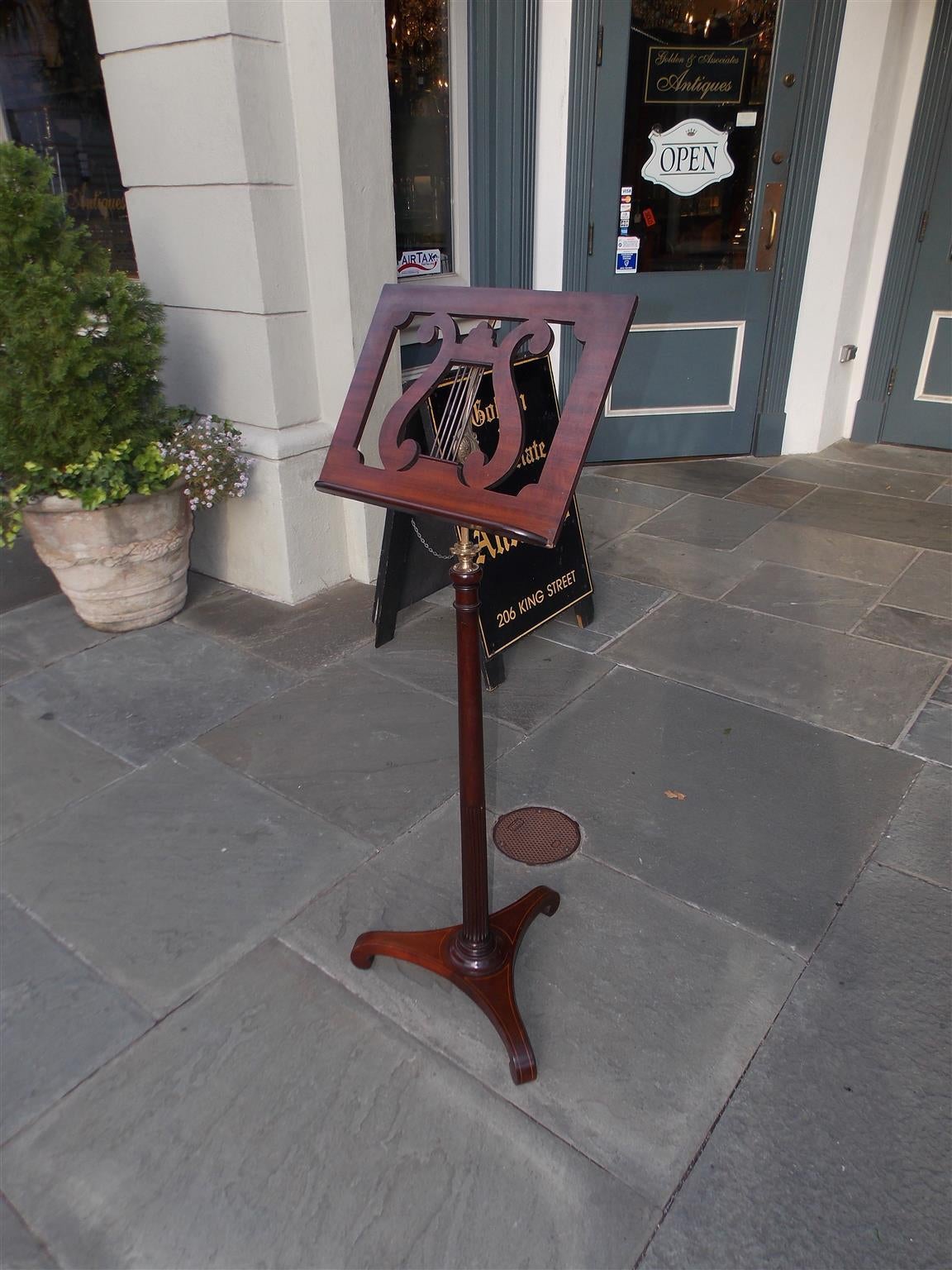 English mahogany lyre music stand with adjustable sheet music rest, ormolu mount with a telescoping fluted shaft, and terminating on tripod base with satinwood scrolled feet. Early 19th Century.