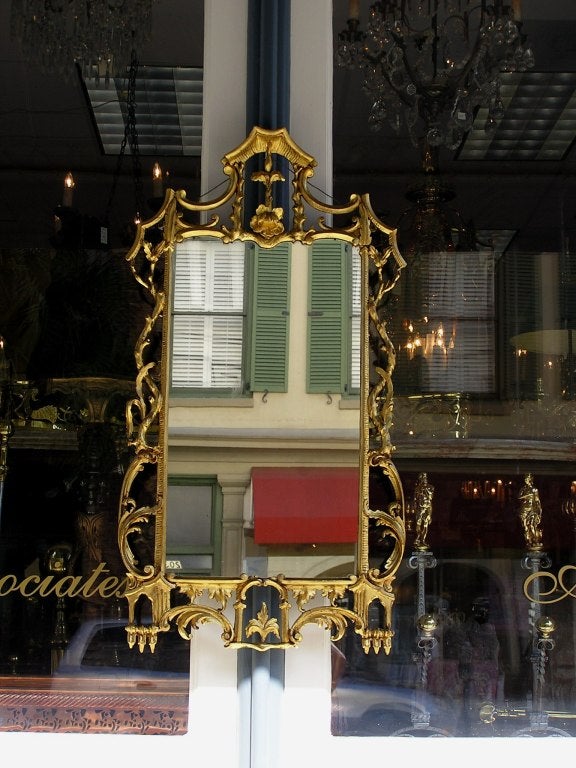 Italian carved wood gold gilt mirror with scrolled acanthus floral motif. Mirror has original glass.