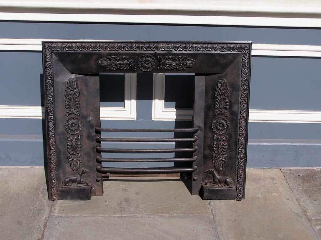 American Regency Tin and Iron fireplace surround with floral molded edge, centered floral filigree, and terminating on opposing whippet plinth base. Baltimore