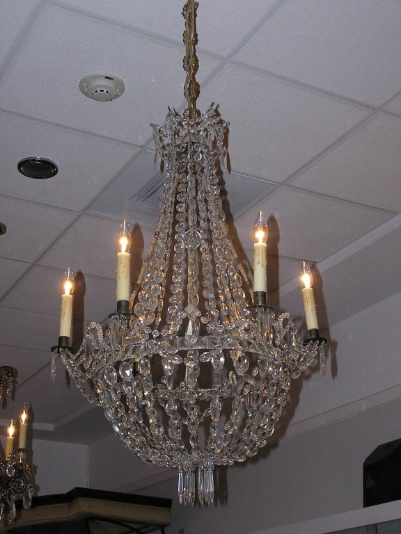 English Regency crystal and bronze six light chandelier. Originally candle powered and has been electrified.