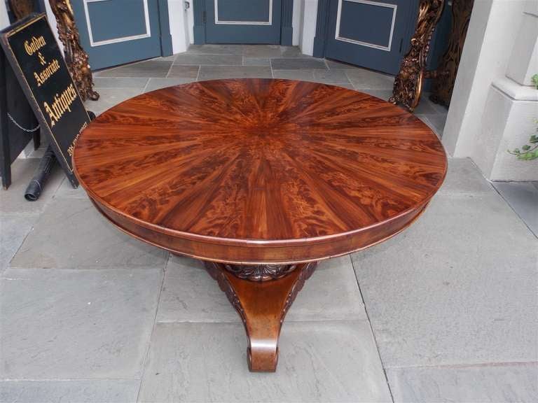 Caribbean pie shaped mahogany tilt top center table with carved acanthus bulbous pedestal terminating on tripod scrolled medallion legs.