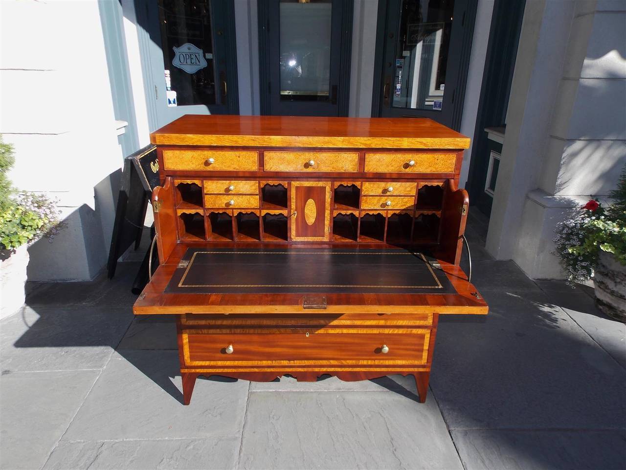 American Hepplewhite mahogany fall front butlers desk with fitted burl Ashe interior, Ashe cross banding drawer fronts, original brasses, carved scalloped skirt, and terminating on tapered feet, Early 19th century.