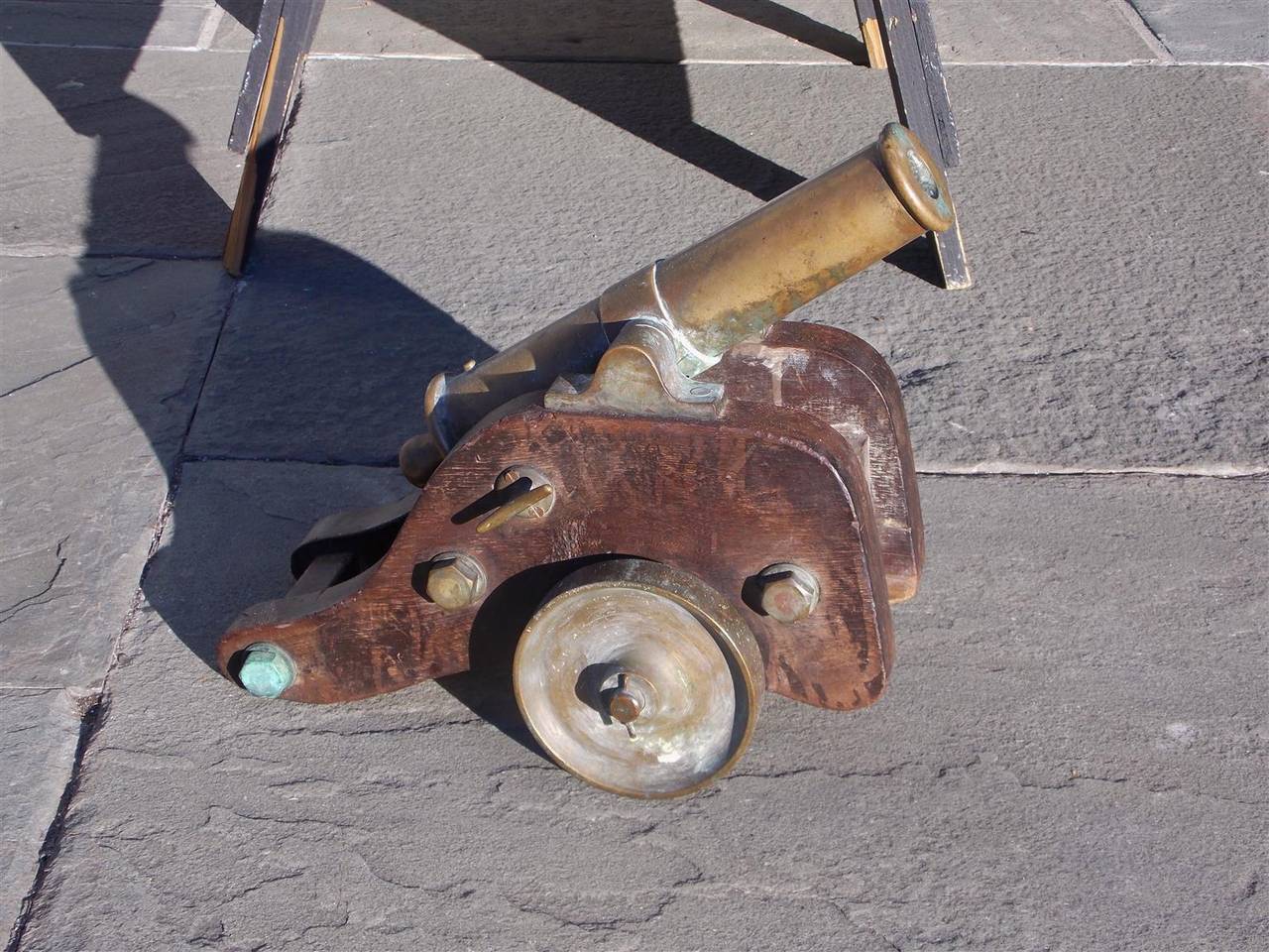English bronze signal cannon on original wood carriage with bronze wheels.  Early 19th Century