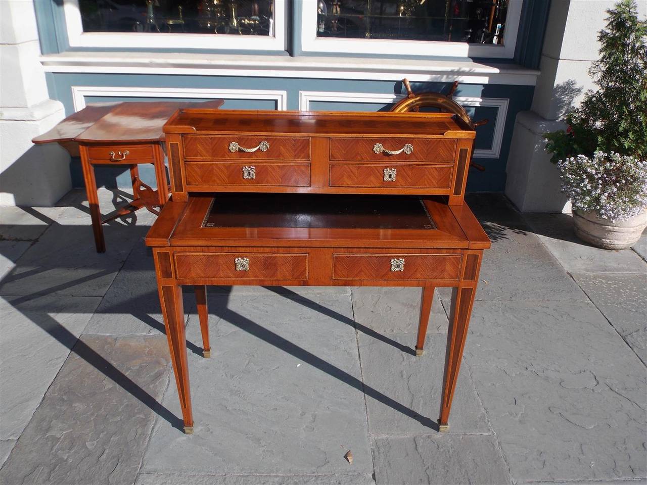 Italian inlaid marquetry leather top six-drawer writing desk with original ormolu brasses, terminating on tapered legs with brass cupped casters, Early 19th Century.