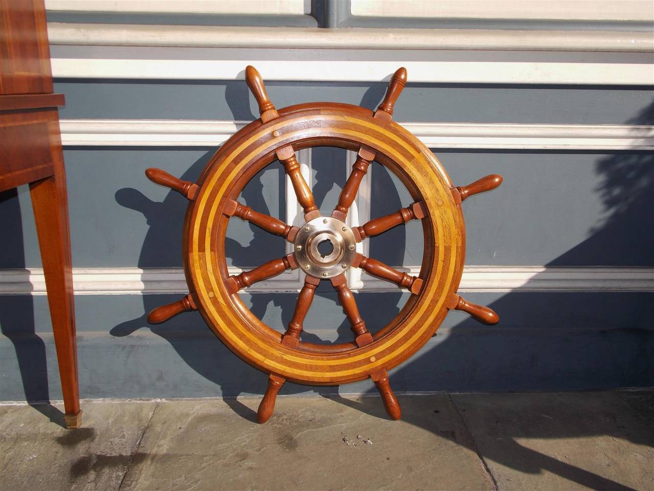 American walnut and maple inlaid eight spoke ships wheel with centered brass hub.  Mid 19th Century.
