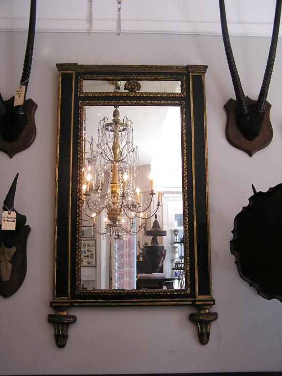 Italian painted and gilt trumeau mirror with centered figure of man, carved decorative gouge work, lambs tongue motif, and terminating on matching inverted beaded floral urns. All original.