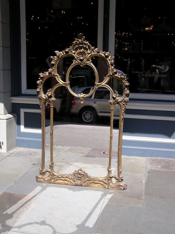 French carved wood and gold gilt over mantel mirror with acanthus, rose, and scrolled floral motif. All original.