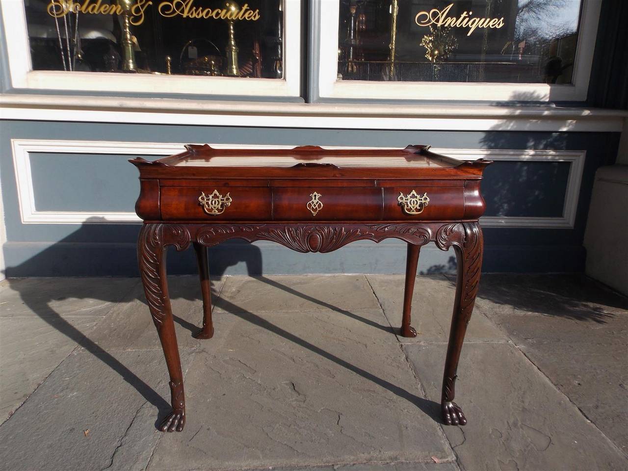 Irish Chippendale mahogany one-drawer dessert table with carved scalloped gallery, original brasses, acanthus carved  skirt, outset knee, and terminating on tapered legs with paw feet. Late 18th Century. All original and finished on all sides.