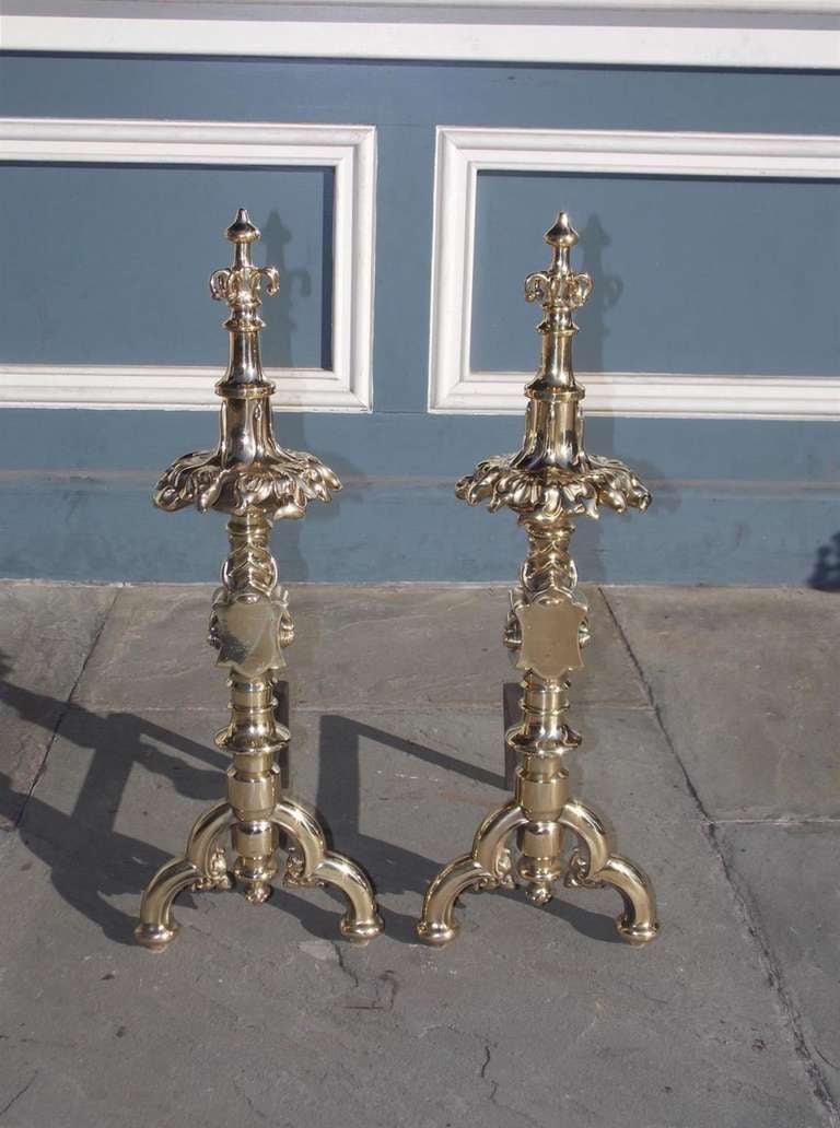 Pair of English bronze Gothic andirons with graduated finials, inverted floral petals,  bulbous squared medallion plinths, and resting on flanking scrolled legs. Early 18th Century. 