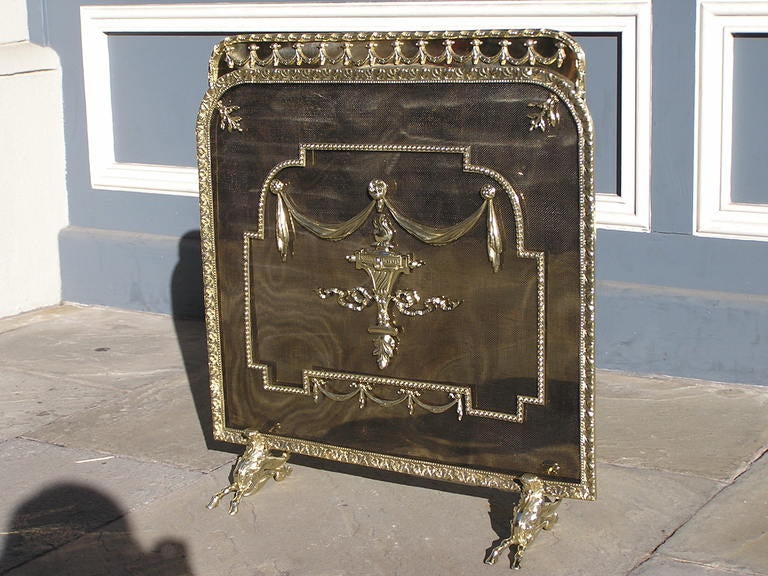 French brass two season firescreen with floral decorative swags, beading, centered urn, and ending on acanthus hoof feet. Dealers please call for trade price.