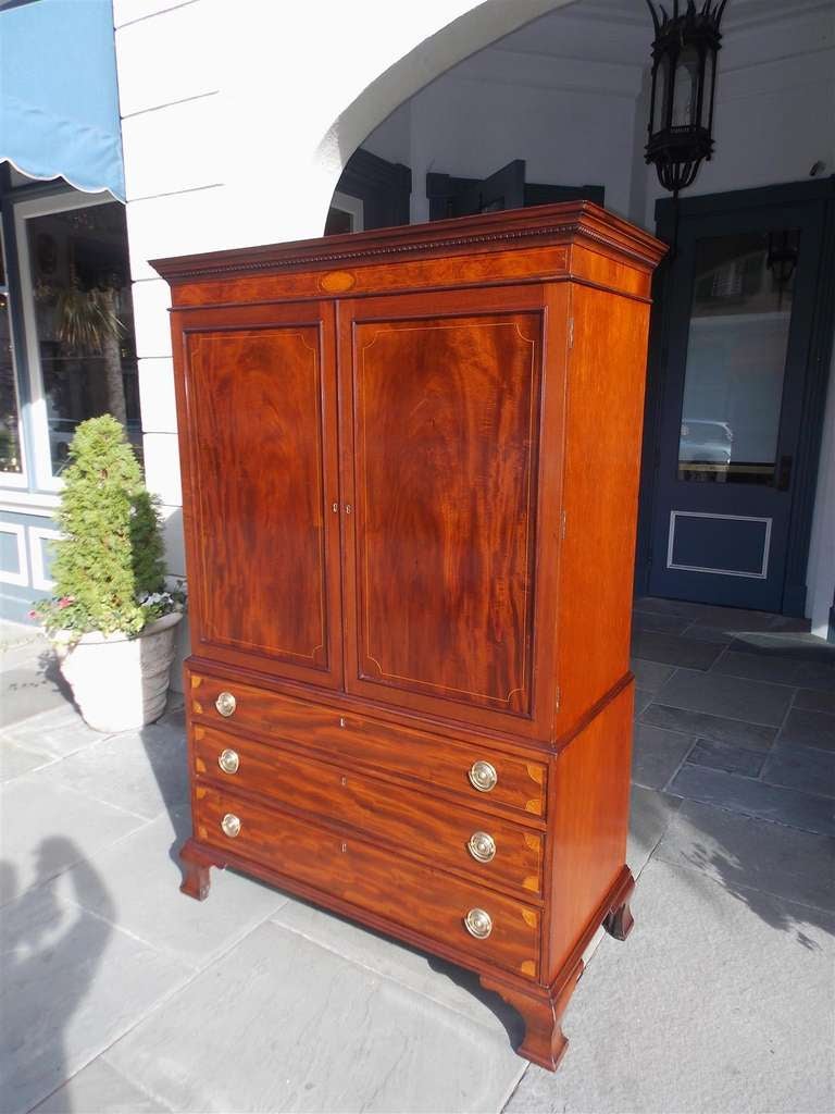 Charleston mahogany graduated three drawer linen press with candlelight molding, oval and corner pateras inlays, interior shelving, original brasses, and terminating on original ogee bracket feet.  Secondary wood consist of White Pine. Charleston