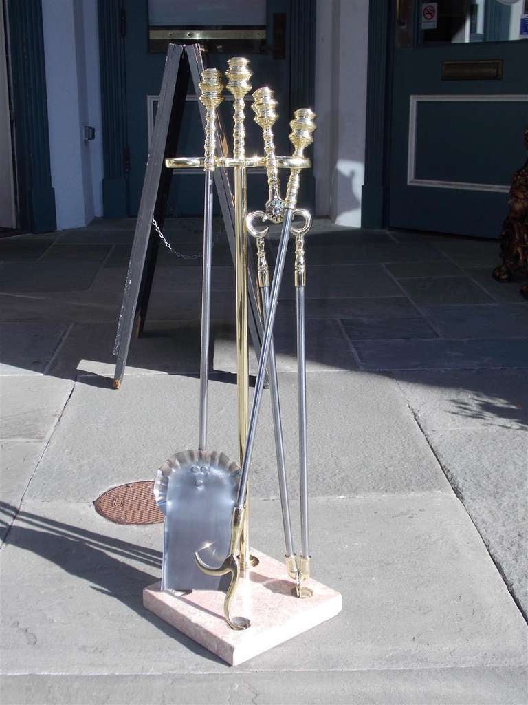 Set of American brass and polished steel tools on marble stand.  Set includes shovel, tongs, and poker.