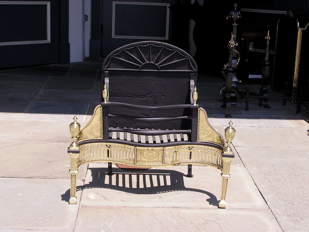 American cast iron and brass serpentine coal grate with decorative beaded fireback, matching hand chased finials, and pierced gallery with beaded floral motif. All original.