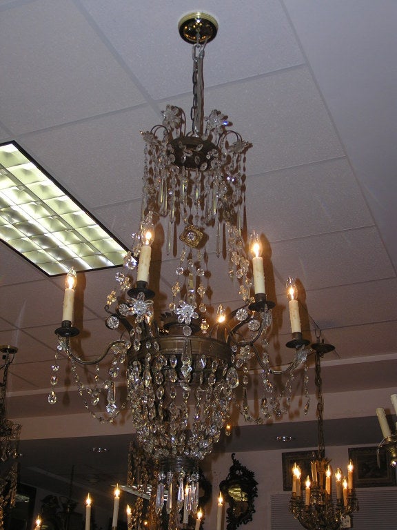 Italian gilt bronze and crystal six light chandelier with scrolled arms, centered urn, and floral motif. Originally candles.