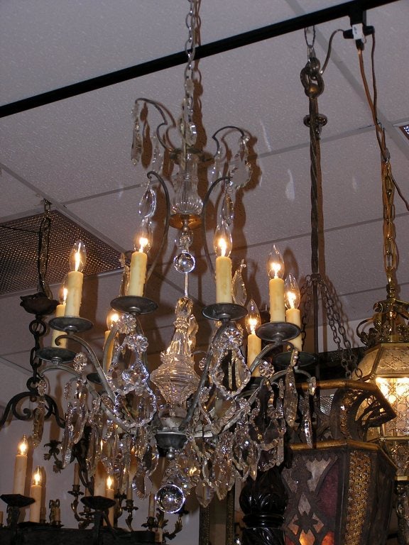 French silver gilt bronze and crystal eight light chandelier with centered crystal column, lower crystal sphere, and centered crystal ball motif. Originally candles.