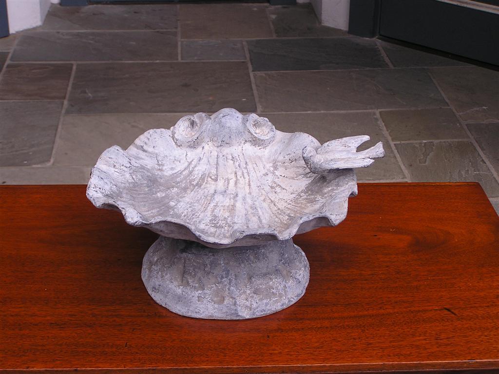 Pair of American lead bird baths with shell molded basins, perched doves, and floral motif terminating on circular plinths. Mid 19th Century