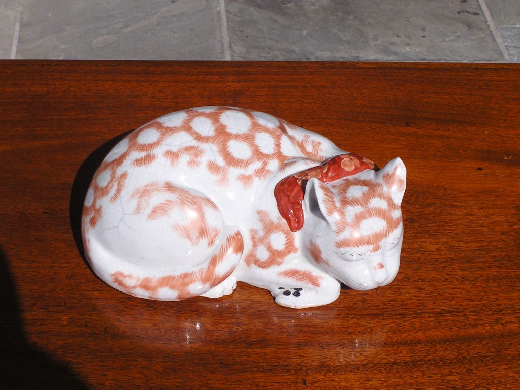Enchanting, large Japanese porcelain Kutani sleeping cat with vibrant colors.