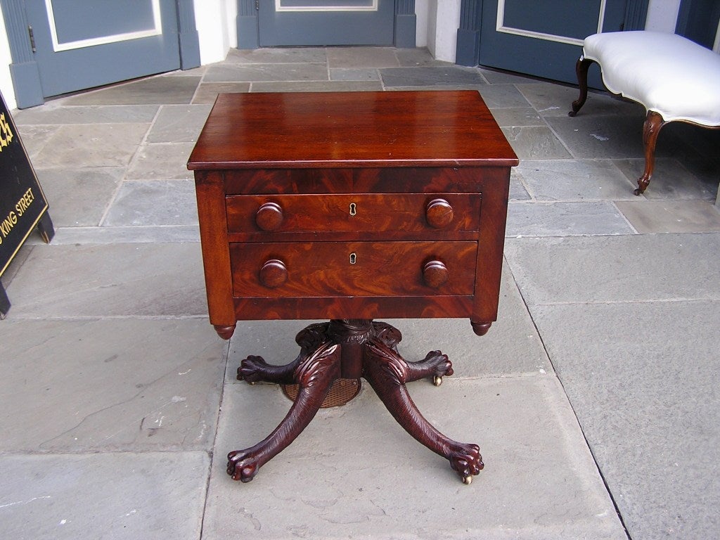 American mahogany two drawer side table with original wood knobs, flanking acorn finials, acanthus hairy carved legs, and terminating on lions paw feet with the original brass casters.  Early 19th Century 