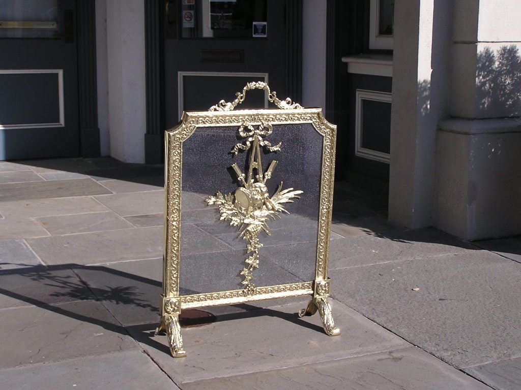 French brass free standing fire screen with floral , ribbon, and acanthus leaf motif. 19th century