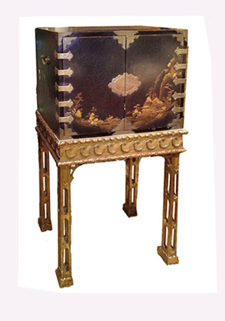 Chinoiserie Cabinet with a pair of doors; raised on a Chinese Chippendale Style giltwood base with carved and reticulated legs.  Partially Composed with 18th Century Elements. 