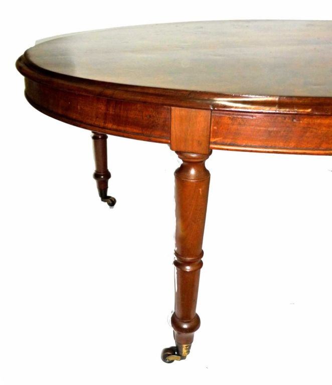 oval, raised on turned and tapering legs ending with brass casters.