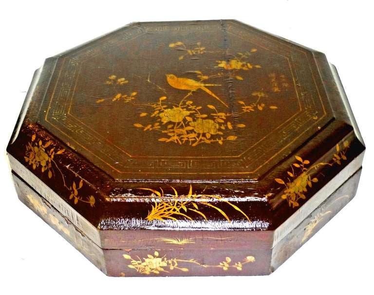 Octagonal, the lid opening to reveal a famille verte dinner service; raised on a conforming base with a shelf.  Circa 1870