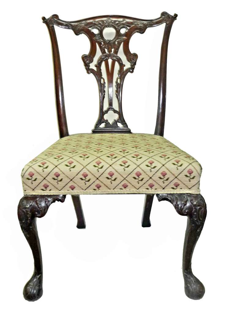 the design for this chair was taken directly from Chippendales GENTLEMAN AND CABINETMAKERS DIRECTOR, plate number XIII, and features carved acanthus leaves, pronounced ears, a reticulated splat; over a needlepointed cover and raised on carved