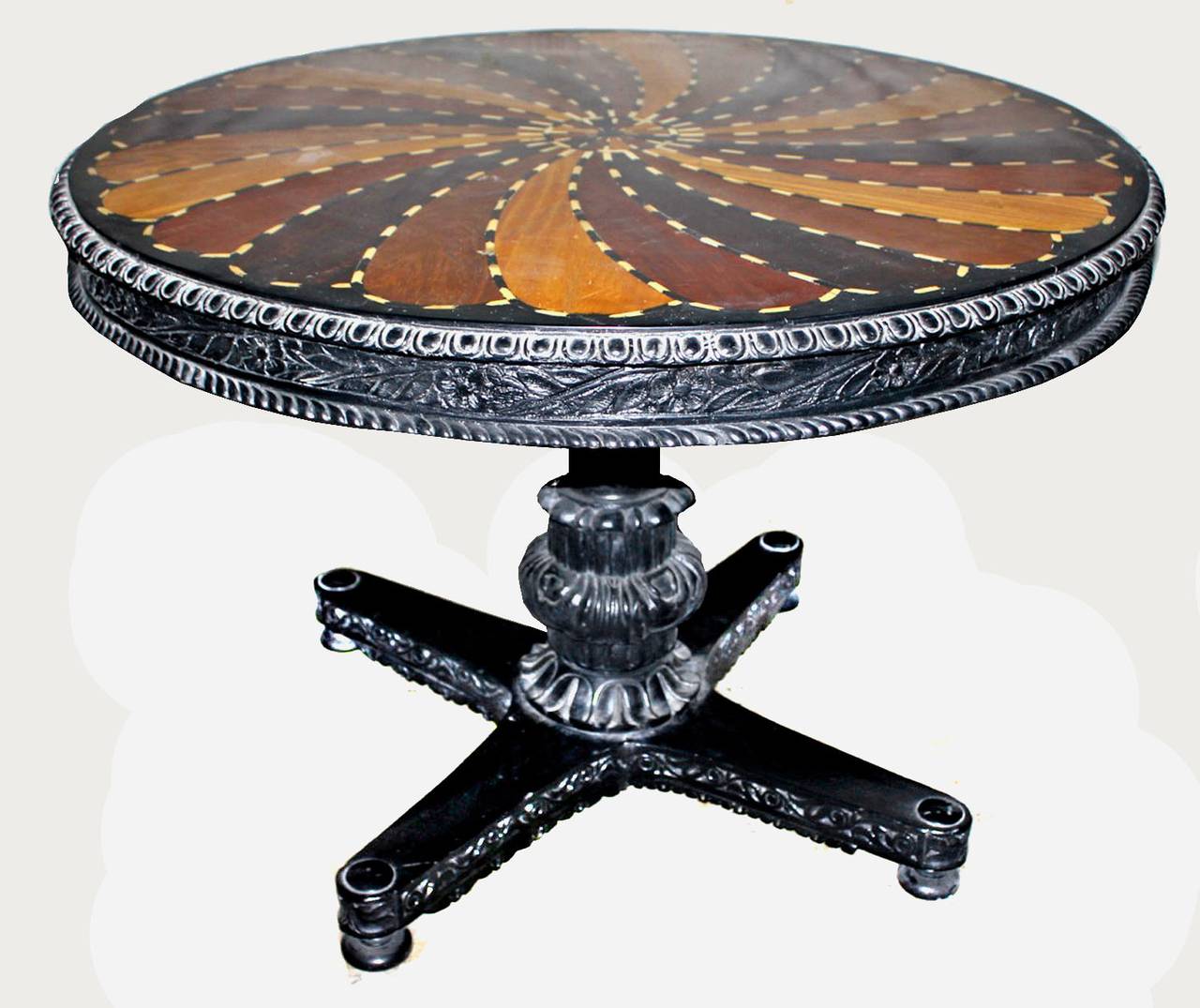 circular tilt-top inlaid with a whorl of specimen veneers. This style was a specialty of the Galle District of Ceylon which was famous for it's specimen-wood furniture. For further information about furniture from this region and a related example