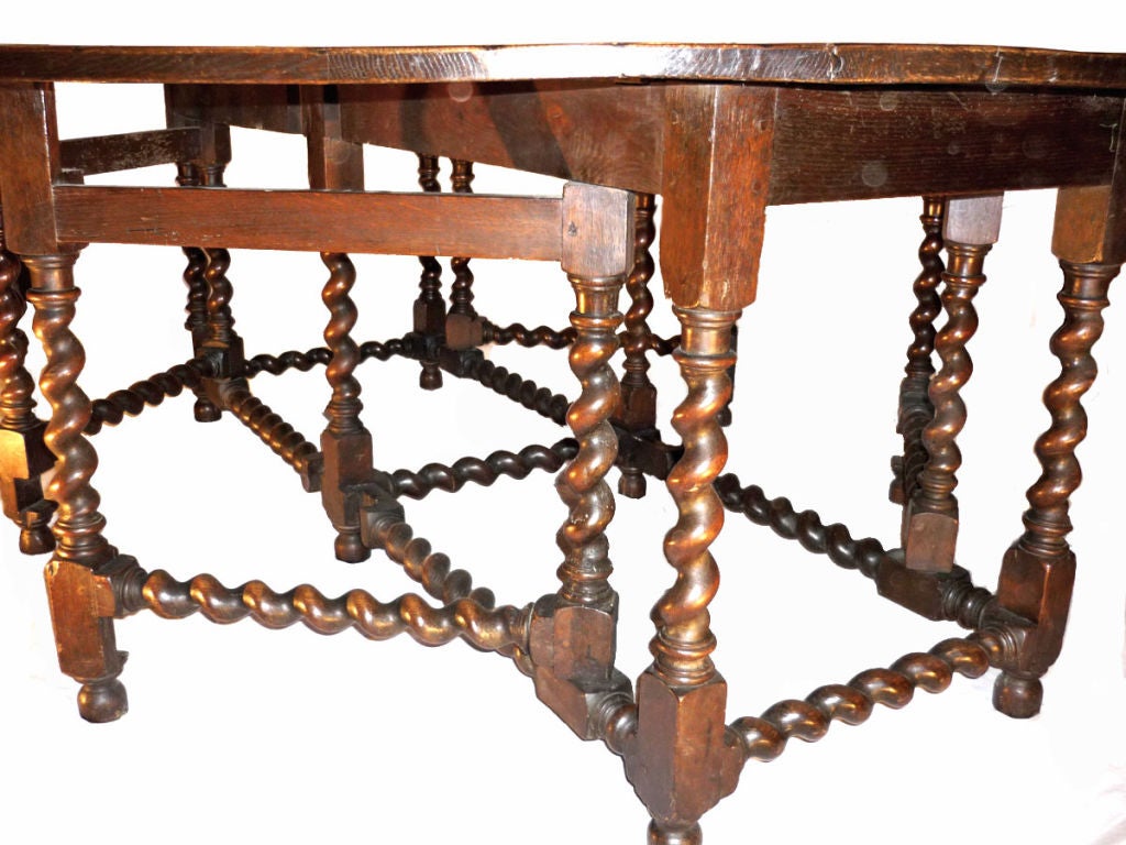 Oval top raised with Barley Twist legs and stretchers throughout, this rare large double gate-leg table has a nicely shaped oval form seldom seen encountered. This form may also be referred to as a Wake Table.  For similar examples see: ENGLISH