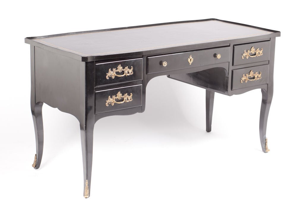 This Louis XV style black lacquer desk with inlaid leather top was created by Bodart Furniture Company of Grand Rapids Michigan during the 1950s.  The quality and workmanship characterize the skill used in making Bodart pieces which were crafted of